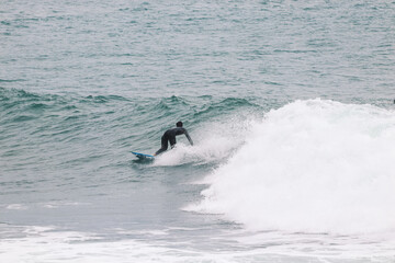 Surfer on Blue Ocean Wave . Surf spot in Ericeira Portugal.