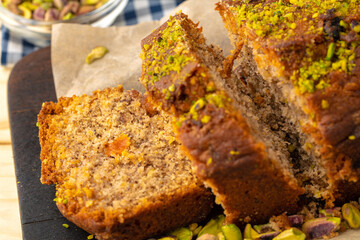 Sponge cake with pistachio on wooden board