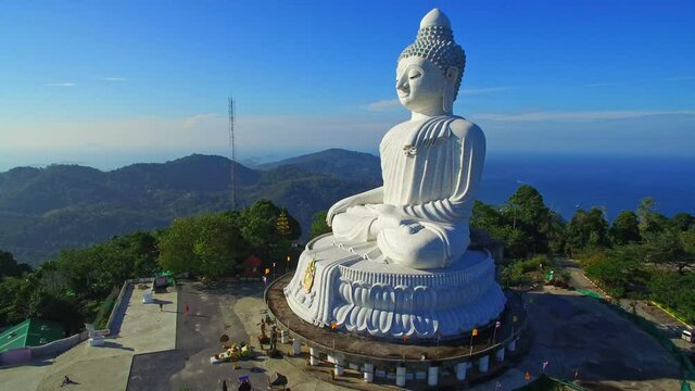 Phuket Big Buddha is one of the island most important and revered landmarks on Phuket island..blue sky and blue sea background.4k video for travel and worship concept.