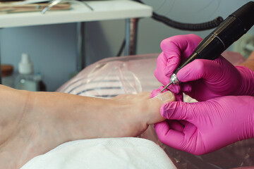 Pedicure and foot care treatment. Female relaxing at salon, caring about nails. Professional pedicure in the beauty salon.