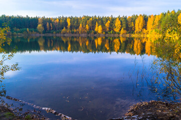 Beautiful forest lake old quarry on a clear autumn day. Forest gave.	