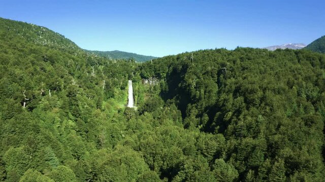 Drone shot of waterfall in the south of chile , near pucon , called "el salto del le&oacute;n" ore waterfall of the lyon. dolly in from even farther away