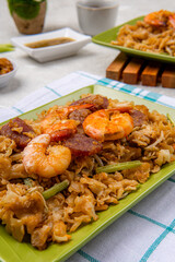 Kwetiau goreng medan or char kway teow It is made from noodles, which are stir fried in cooking oil with garlic, onion or shallots, pork, fried prawn, sliced bakso (meatballs) 
