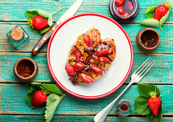 Chicken meat baked in strawberry sauce,wooden background