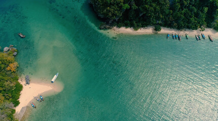 AERIAL. Top view of green island and beach with traditional thai boat at the sunset.