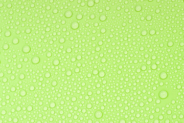 Water drops on green background texture. Backdrop glass covered with drops of water. green bubbles in water.