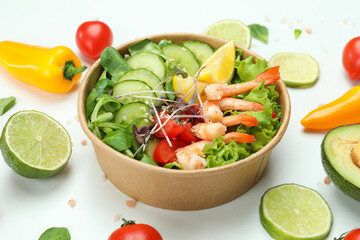 Tasty shrimp salad and ingredients on white background