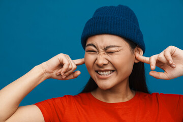 Happy young asian woman in casual clothes standing