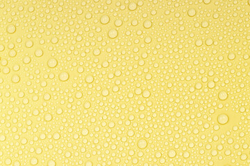 Water drops on yellow background texture. Backdrop glass covered with drops of water. yellow bubbles in water. beer texture