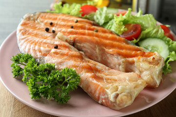 Concept of tasty eating with grilled salmon, close up