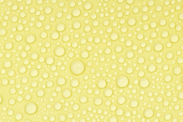 Water drops on yellow background texture. Backdrop glass covered with drops of water. yellow bubbles in water. beer texture