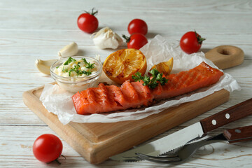 Concept of tasty eating with grilled salmon, close up