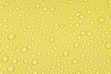 Water drops on yellow background texture. Backdrop glass covered with drops of water. yellow bubbles in water. beer texture