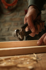 Carpenter pulling the nail with carpenters pincers.