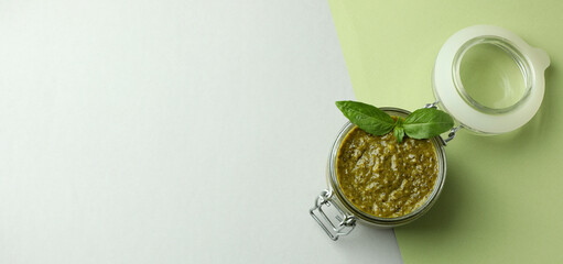 Jar of Pesto sauce on two tone background © Atlas
