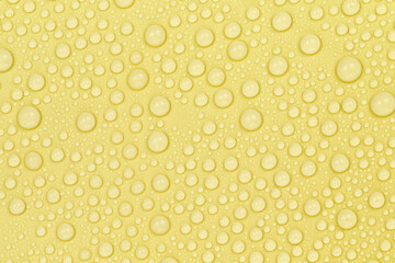 Water drops on yellow background texture. Backdrop glass covered with drops of water. yellow bubbles in water. beer texture