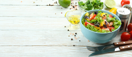 Concept of tasty eating with shrimp salad on white wooden table