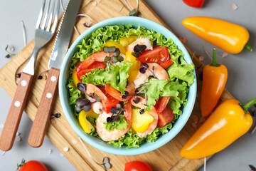 Concept of tasty eating with shrimp salad on gray background
