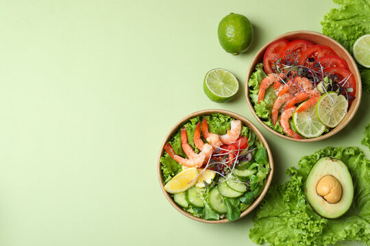 Tasty shrimp salad on green background, space for text