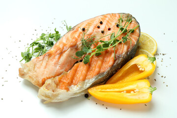 Tasty grilled salmon and ingredients on white background