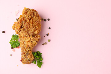 Tasty fried chicken on pink background, space for text