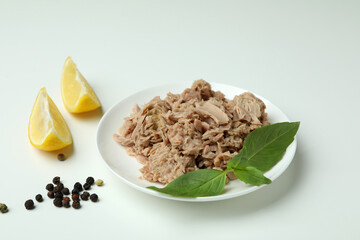 Plate of tasty canned tuna on white background