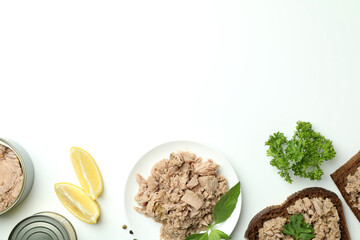 Concept of tasty eating with canned tuna on white background