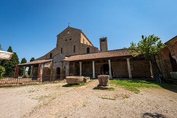 Fototapeta na wymiar Facade of the Basilica and Cathedral of Santa Maria Assunta in Venetian-Byzantine style (639) in Torcello island, one of the oldest churches in Venice, UNESCO world heritage site, Veneto, Italy. 