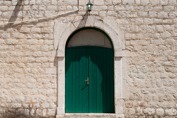 Fototapeta na wymiar Green Door and Old Wall in Kotor, Montenegro