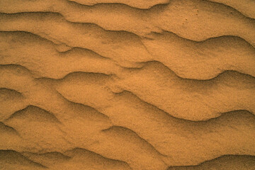 Fototapeta na wymiar Sand pattern with wavy lines