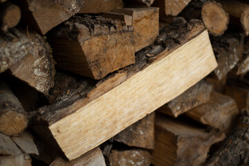 Logs in a woodpile. The firewood is in a pile.
