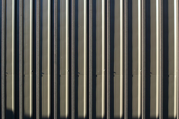 Fence texture. Close-up shot of a ribbed metal structure. Metal fence.