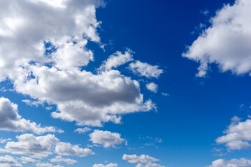 Blue sky background with white clouds.Cloudscape. Sunny day. Cumulus cloud.the sun hiding under the clouds