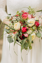 Bride holds a bridal bouquet in her hand. Bridal bouquet 