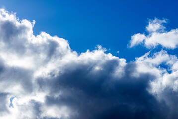 Dramatic blue sky with white clouds background.