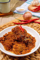 Rendang Pork or Rendang babi. 

Rendang babi is often described as a rich dish of meat  that has been slow cooked and braised in a coconut milk seasoned with a herb and spice mixture.