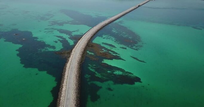 4k aerial clip of Eriskay causeway road, Outer Hebrides, Scotland. Sunny day, beautiful green sea water.