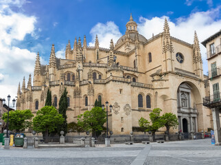 Fototapeta na wymiar Majestic front view at the iconic spanish gothic building at the Segovia cathedral, towers and domes, downtown city