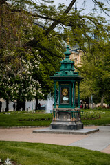 Historic meteorological column, Smetanovy sady (Smetana Park) municipal park in center of Plzen in sunny day, green trees, flowering chestnuts, Pilsen, Western Bohemia, Czech Republic