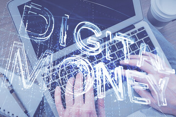 Double exposure of man's hands typing over computer keyboard and crypto currency theme hologram drawing. Top view. Blockchain concept.