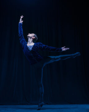 Young and graceful ballet dancer isolated on dark background in neon light. Art, action, inspiration concept.