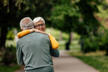 Fototapeta premium Senior husband, gently holding his wife in his arms.