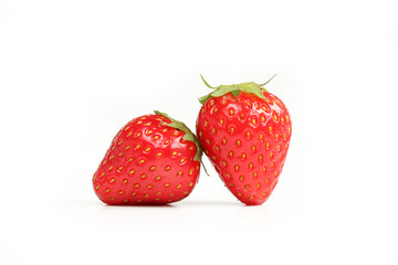 Two shiny strawberries isolated on white background