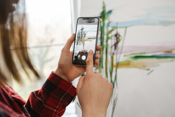 Young white woman painter holding paintbrush