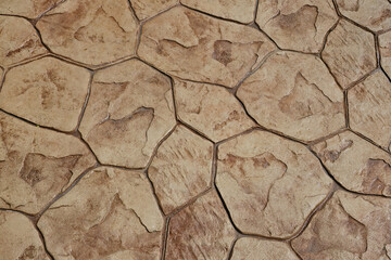 Stone block pavement. Brown paving slabs, close up. Pattern of paving blocks, top view