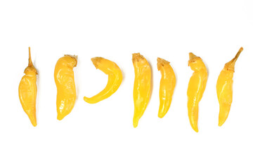 Set of different yellow hot peppers isolated on white background. Spicy paprika vegetables