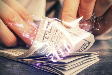 Multi exposure of handshake drawing hologram and USA dollars bills and man hands.