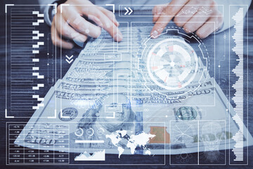 Double exposure of technology drawing hologram and us dollars bills and man hands. Data concept