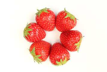 Top view of fresh strawberries with green leaves isolated on white background