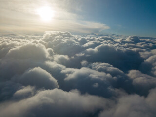 Obraz na płótnie Canvas Aerial high flight above the clouds at sunrise.